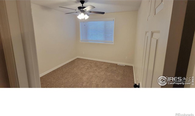 carpeted spare room featuring ceiling fan