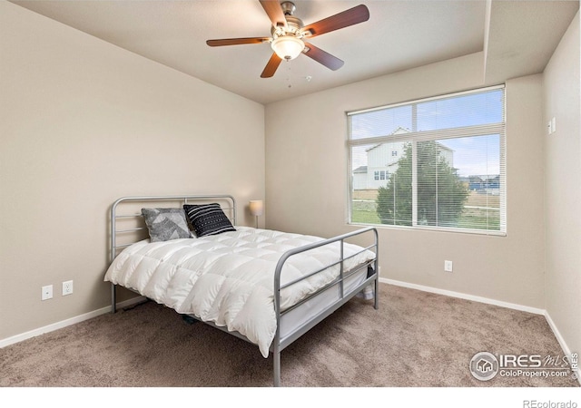 bedroom featuring ceiling fan and light carpet