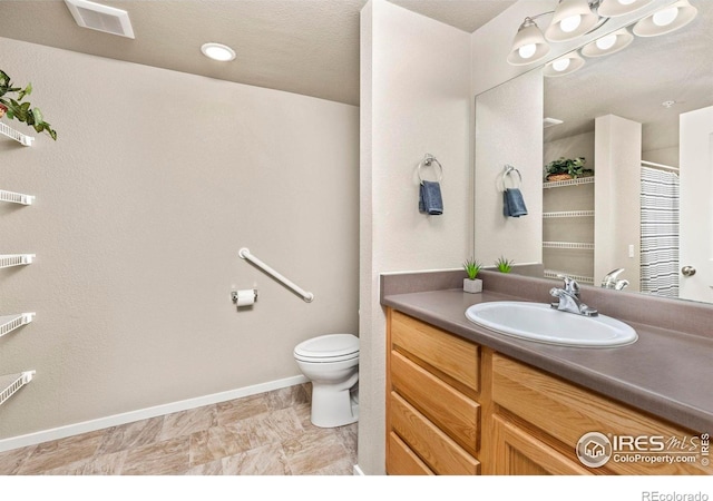 bathroom featuring vanity and toilet