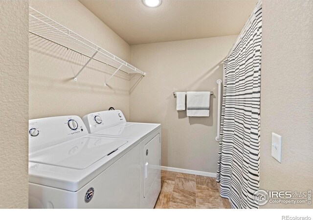 laundry area featuring washing machine and clothes dryer