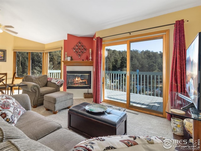 living room featuring ceiling fan, light colored carpet, and lofted ceiling