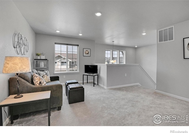 carpeted living room featuring a wealth of natural light