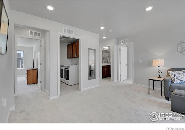 living room featuring washer and dryer and light colored carpet