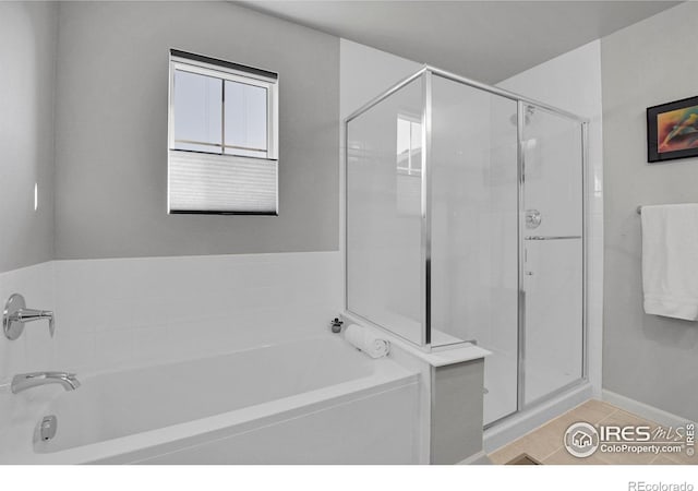 bathroom with separate shower and tub and tile patterned floors