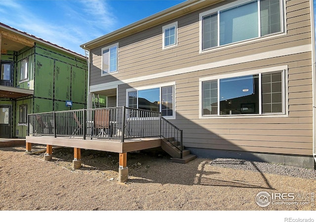 back of house featuring a wooden deck