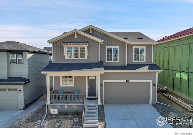 view of front of home featuring a porch and a garage