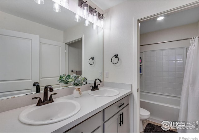 full bathroom featuring toilet, shower / bath combo, and vanity