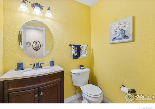 bathroom with toilet and vanity