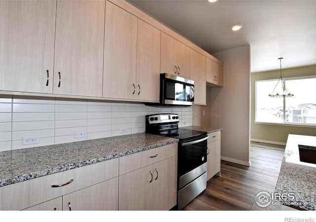 kitchen featuring light brown cabinets, light stone counters, dark hardwood / wood-style floors, decorative backsplash, and stainless steel appliances