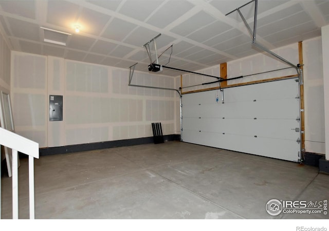 garage featuring electric panel and a garage door opener