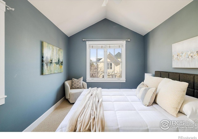 carpeted bedroom featuring lofted ceiling