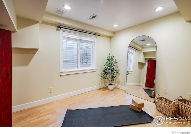 workout room featuring hardwood / wood-style floors