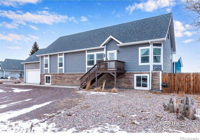 view of front facade with a garage and a deck