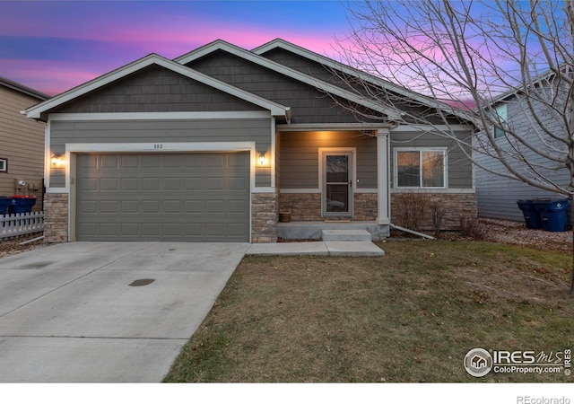 craftsman inspired home featuring a lawn and a garage