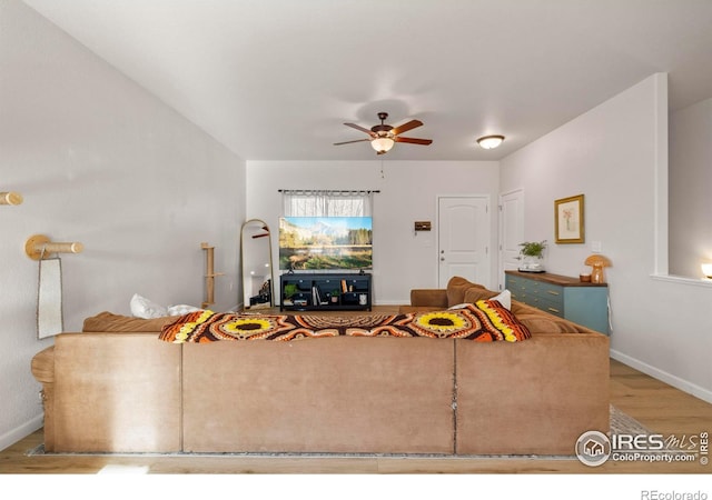 living room featuring light wood-type flooring and ceiling fan