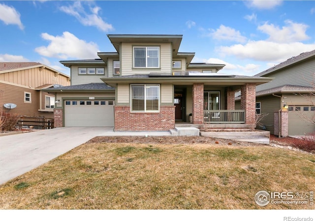 prairie-style home featuring a front yard, covered porch, and a garage