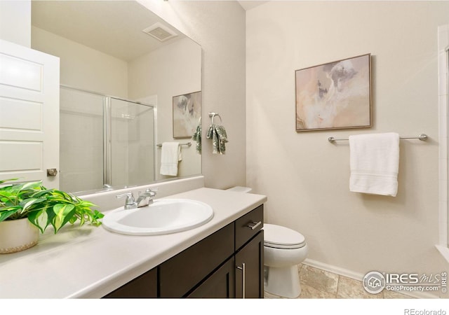 bathroom with walk in shower, vanity, and toilet