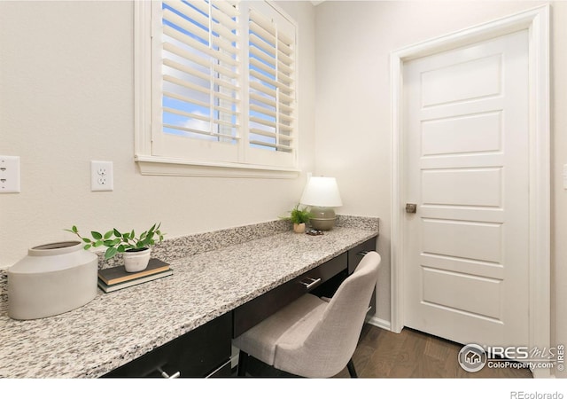 office featuring built in desk and dark hardwood / wood-style flooring