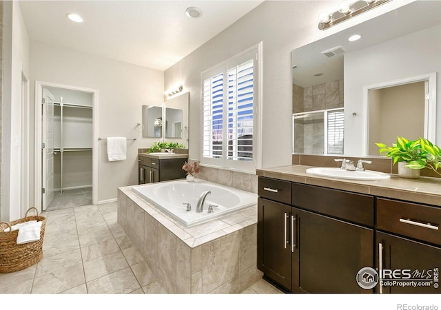 bathroom with independent shower and bath and vanity