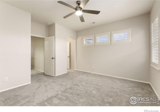 unfurnished bedroom with ceiling fan and light carpet