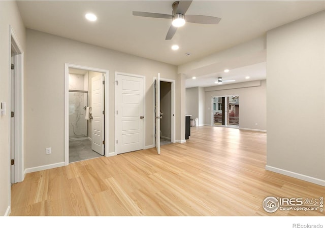 unfurnished bedroom featuring ceiling fan, light hardwood / wood-style flooring, and connected bathroom