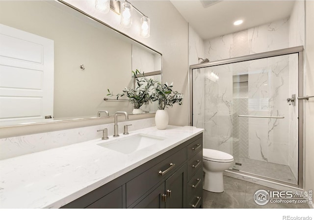 bathroom with toilet, walk in shower, and vanity