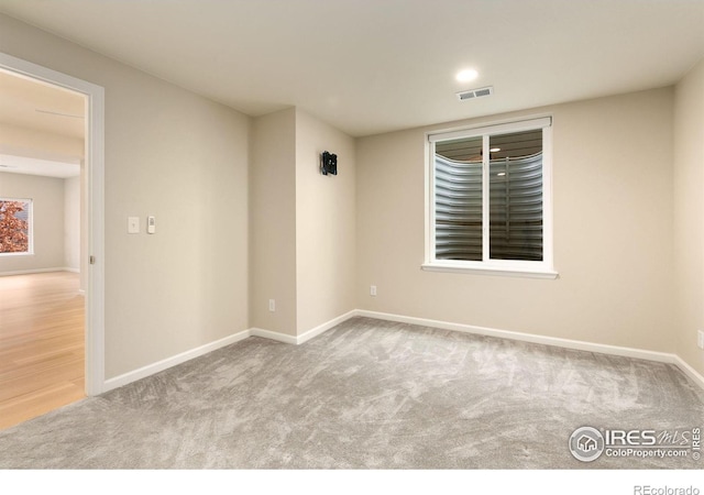 empty room featuring light colored carpet