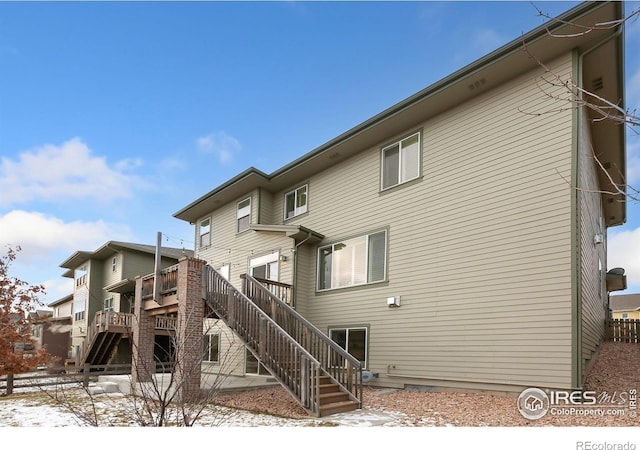 snow covered property featuring a wooden deck