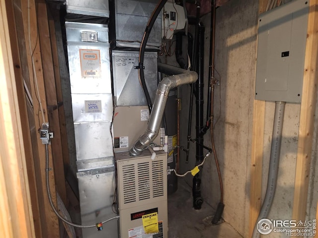 utility room with electric panel and heating unit