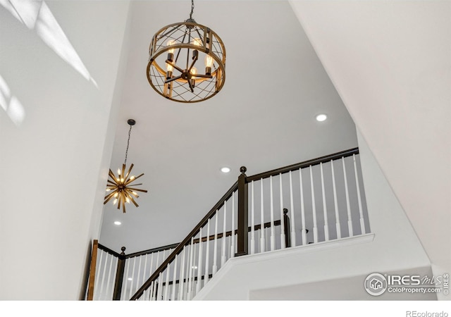 stairway featuring a chandelier