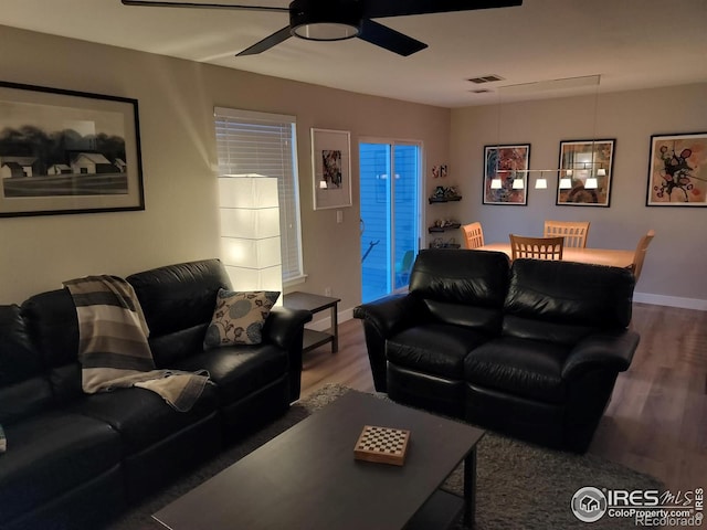 living room with ceiling fan and hardwood / wood-style floors