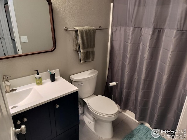 bathroom featuring toilet, tile patterned floors, and vanity