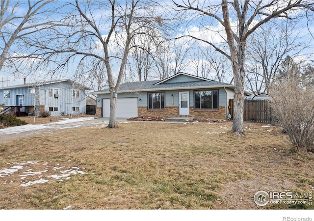 view of front of house with a garage and a front lawn