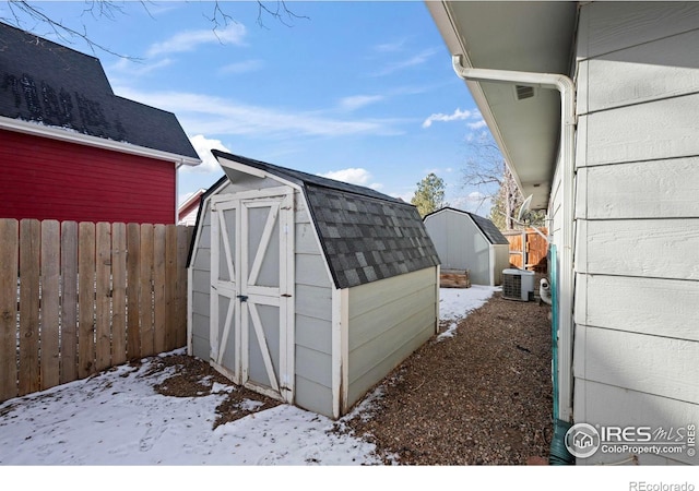 snow covered structure featuring cooling unit