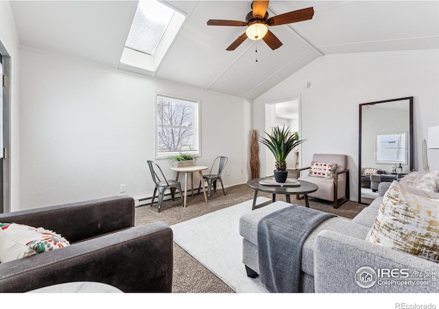 living room featuring ceiling fan, carpet flooring, baseboard heating, and vaulted ceiling with skylight