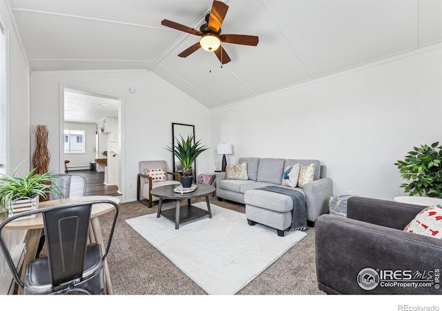 living room featuring lofted ceiling, ceiling fan, and carpet