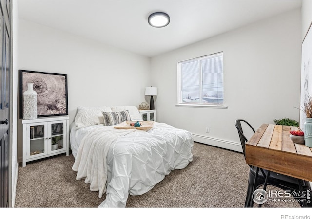 carpeted bedroom featuring baseboard heating