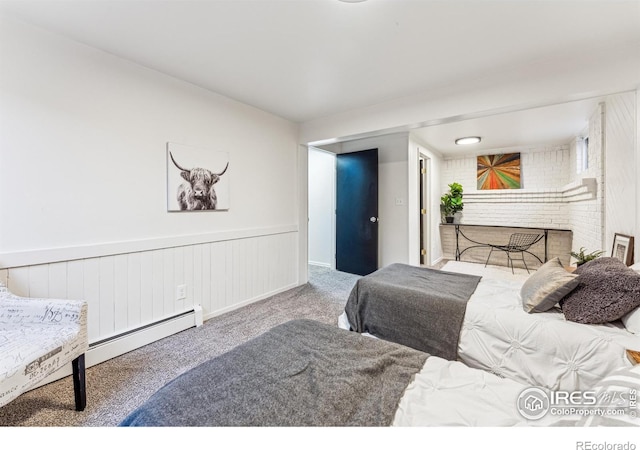 bedroom featuring a fireplace, baseboard heating, and carpet