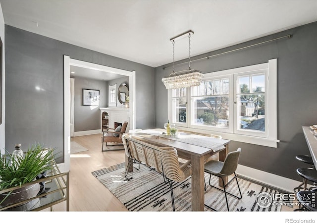 dining area featuring a chandelier and light hardwood / wood-style floors