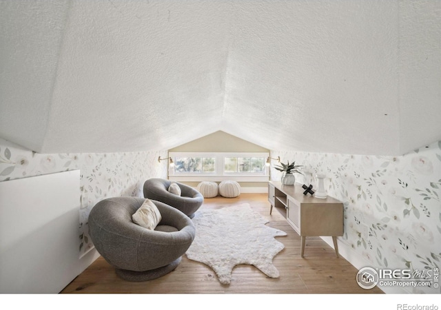 interior space featuring lofted ceiling and hardwood / wood-style flooring