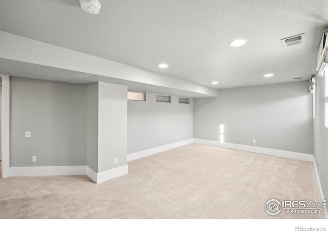 basement featuring light carpet