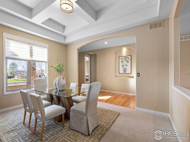 dining room featuring beamed ceiling, carpet floors, and coffered ceiling