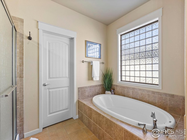 bathroom featuring shower with separate bathtub and tile patterned floors