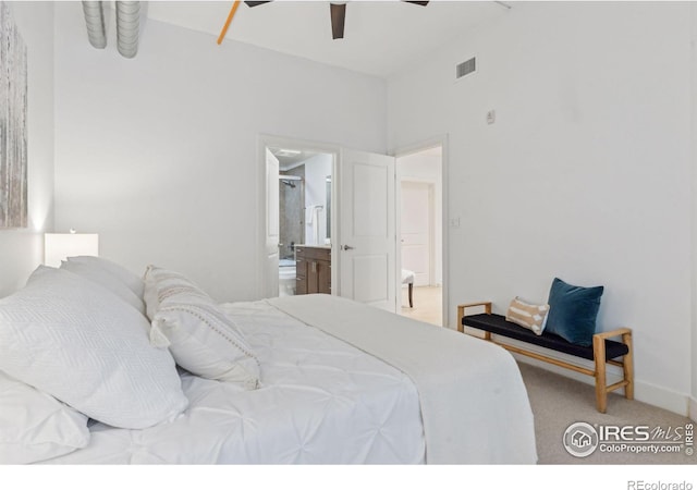 carpeted bedroom featuring connected bathroom and ceiling fan