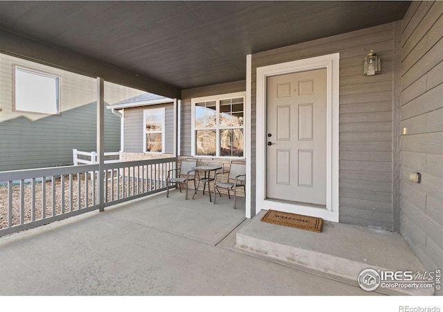 entrance to property featuring a porch