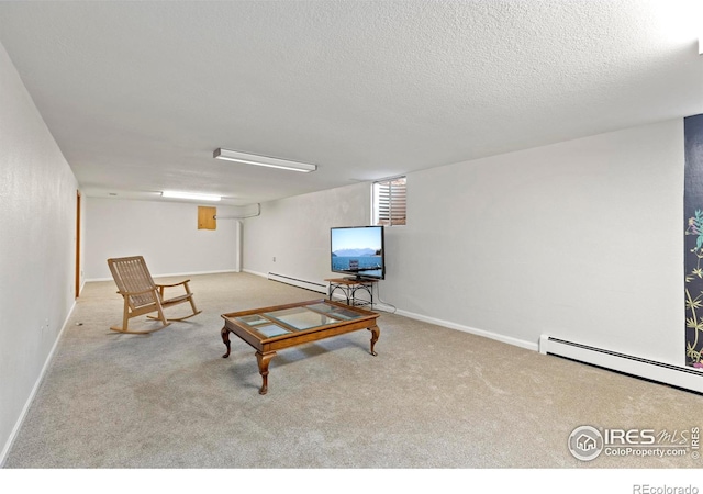 carpeted living room with baseboard heating and a textured ceiling