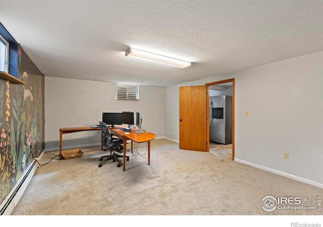 carpeted office space with a textured ceiling and a baseboard heating unit