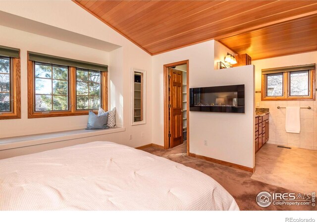 bedroom featuring wooden ceiling, connected bathroom, vaulted ceiling, and carpet flooring