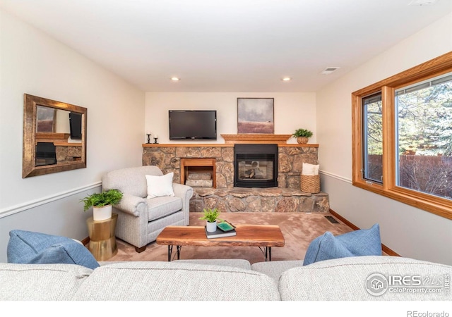 living room with a stone fireplace