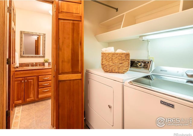 laundry room with independent washer and dryer and sink